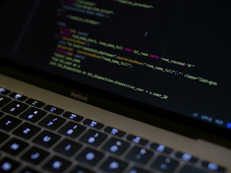 A laptop showing the code behind a web platform